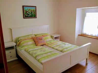 a bed with two pillows on it in a bedroom at Rock&Lodge in Bohinj