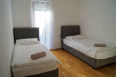 two beds sitting next to each other in a room at Maline Apartments in Bled
