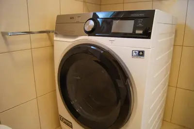 a white washing machine in a bathroom at Maline Apartments in Bled