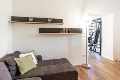 a living room with a couch and a table at Apartment Trieste HerMes arT in Sežana