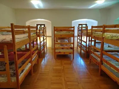 a room filled with lots of bunk beds at Dom Pristava in Jesenice