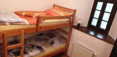 a bedroom with two bunk beds and a window at Dom Pristava in Jesenice