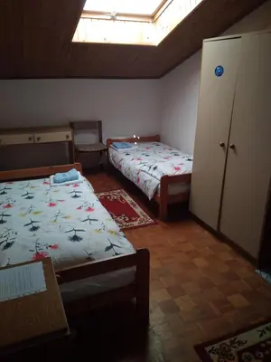 a bedroom with two beds and a skylight at Gostišče Oddih in Solkan