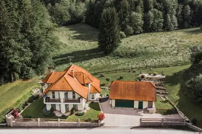 an aerial view of a house with an orange roof at House of Adventure - The Base to explore Slovenia in Laze v Tuhinju