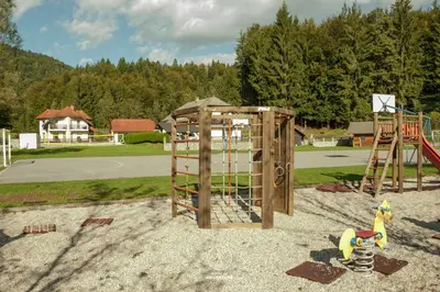 a playground with a play equipment in a park at House of Adventure - The Base to explore Slovenia in Laze v Tuhinju