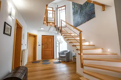a staircase in a living room with a stair case at House of Adventure - The Base to explore Slovenia in Laze v Tuhinju