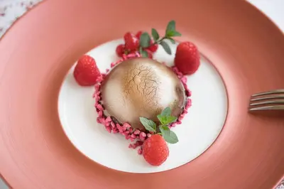 a chocolate dessert on a plate with strawberries at Hotel Jozef in Idrija