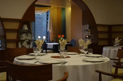 a table in a restaurant with a white table cloth at Hotel Jozef in Idrija