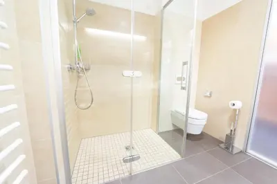 a bathroom with a shower with a toilet at Hotel Jozef in Idrija