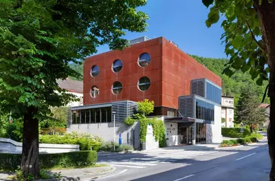 a red brick building on the side of a street at Hotel Jozef in Idrija