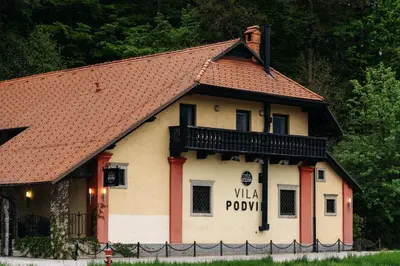 a building with a sign on the side of it at Vila Podvin in Radovljica