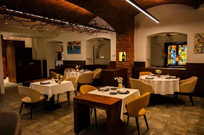 a dining room with white tables and chairs at Vila Podvin in Radovljica