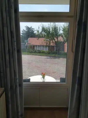 a window with a view of a brick road at Accomodation Pertout in Nova Gorica