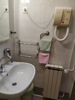 a bathroom with a sink and a phone on the wall at Accomodation Pertout in Nova Gorica