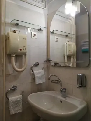 a bathroom with a sink and a mirror at Accomodation Pertout in Nova Gorica