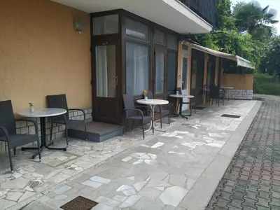 a patio with tables and chairs next to a building at Accomodation Pertout in Nova Gorica