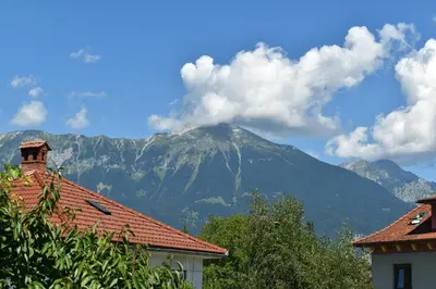 a mountain in the distance with houses and trees at Apartments Apple Garden **** in Bled
