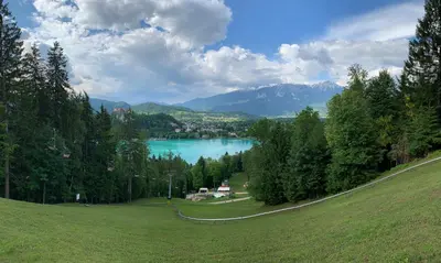 a view of a lake in the middle of a field at Apartments Apple Garden **** in Bled