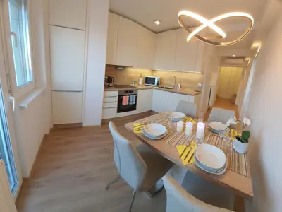 a kitchen with a table with chairs and a dining room at Ljubljana sky view in Ljubljana