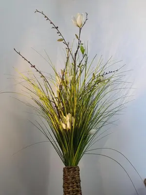 a vase with white flowers and grass in it at Ljubljana sky view in Ljubljana