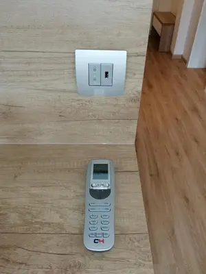 a remote control sitting on the floor next to a lightswitch at Ljubljana sky view in Ljubljana