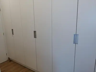 a row of white cabinets in a room at Ljubljana sky view in Ljubljana
