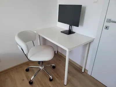 a white desk with a computer monitor and a chair at Ljubljana sky view in Ljubljana