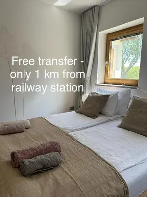 two beds in a bedroom with words free transfer only km from railway station at Zenja Apartments - Free Private Parking - Škocjan caves - Cozy garden in Divača