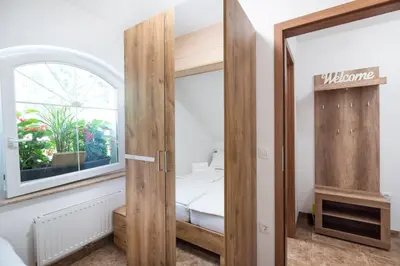 a small room with a bed and a window at Apartments Grad Kamen in Begunje na Gorenjskem