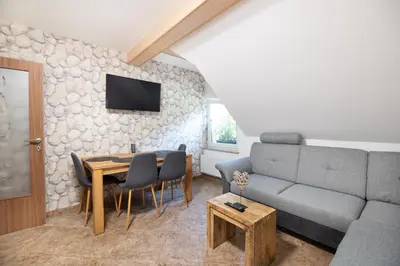a living room with a couch and a table at Apartments Grad Kamen in Begunje na Gorenjskem
