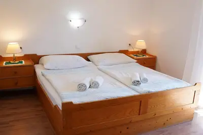 a bedroom with two beds with slippers on them at Penzion Rožič in Bohinj