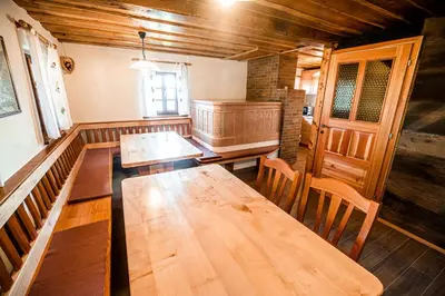 a dining room with wooden tables and chairs at Sleme house in Krška Vas