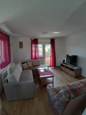a living room with a couch and a tv at Apartma Dominik in Zgornje Gorje