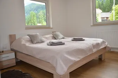 a bed with two towels on it in a bedroom at Apartmaji Gaby in Gozd Martuljek
