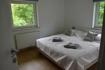 a bedroom with a bed with two towels on it at Apartmaji Gaby in Gozd Martuljek