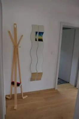a room with a white wall with a wooden object at Apartmaji Gaby in Gozd Martuljek