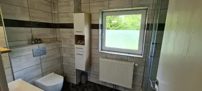 a bathroom with a toilet and a window at Apartmaji Gaby in Gozd Martuljek