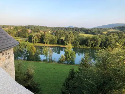 a view of a lake with trees in a field at Vinica Castle Boutique & Spa Hotel in Vinica