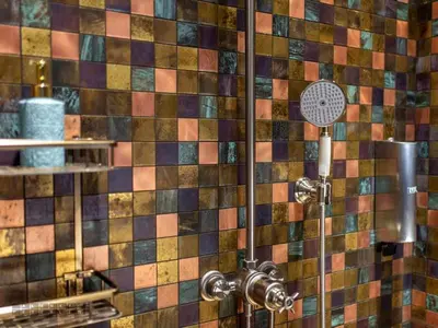 a shower in a bathroom with colorful tiles at Vinica Castle Boutique & Spa Hotel in Vinica