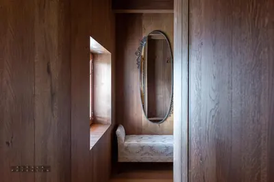 a hallway with a mirror and a chair in a room at Vinica Castle Boutique & Spa Hotel in Vinica
