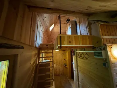 an inside view of a cabin with wooden walls and ceilings at Mountain Lodge Suška Koča in Stahovica