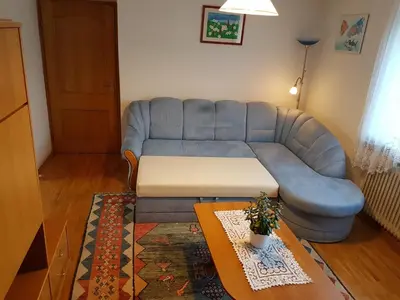 a living room with a blue couch and a table at Apartment Venko in Slovenske Konjice