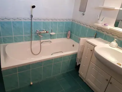 a bathroom with a bath tub and a sink at Apartment Venko in Slovenske Konjice
