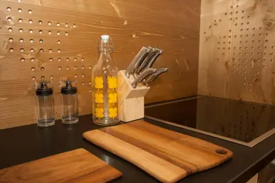 a kitchen counter with a bottle and a knife block at Family fun Pohorje in Ruše