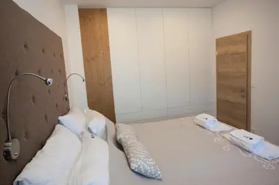 a bedroom with a bed with two phones on it at Family fun Pohorje in Ruše
