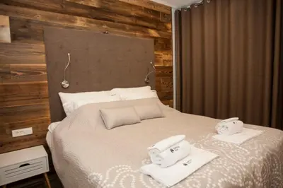 a bedroom with a bed with two towels on it at Family fun Pohorje in Ruše