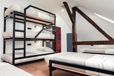 a room with two bunk beds and two beds at Hostel Vila Pohorje in Slovenj Gradec