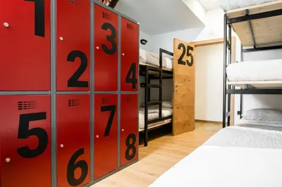 a room with a bunch of bunk beds at Hostel Vila Pohorje in Slovenj Gradec