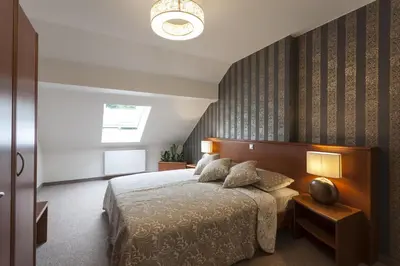 a bedroom with a large bed and a window at Duplex Penthouse Aparthotel Rosa in Podčetrtek