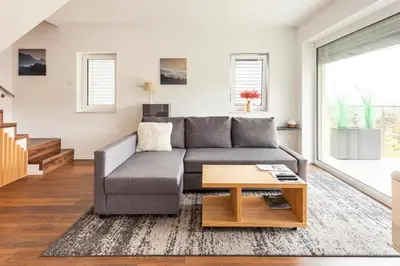 a living room with a couch and a table at Hillhouse Novo mesto in Novo Mesto
